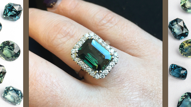 Green Sapphire Engagement Ring on a hand.