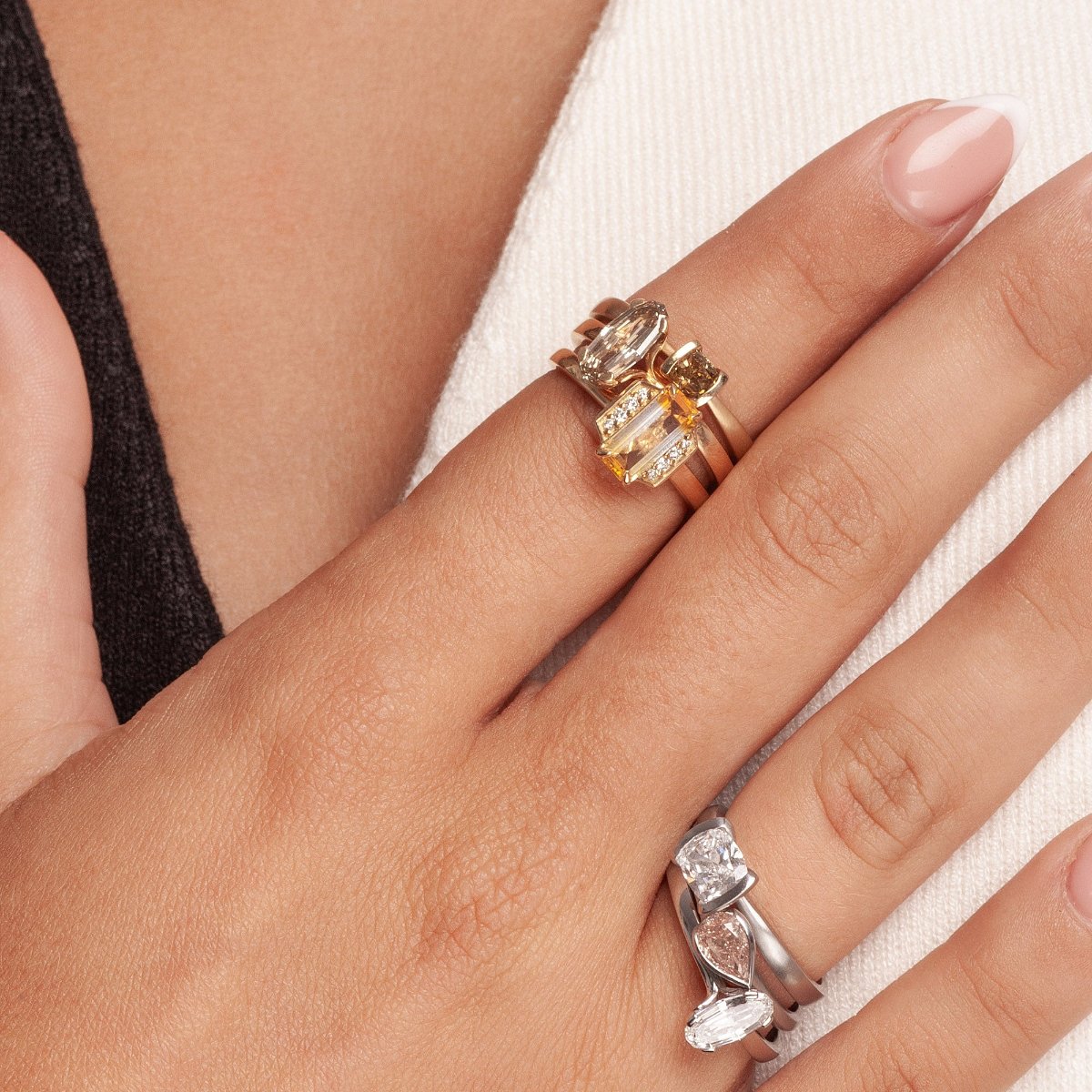 Yellow parti sapphire ring stack on models hand