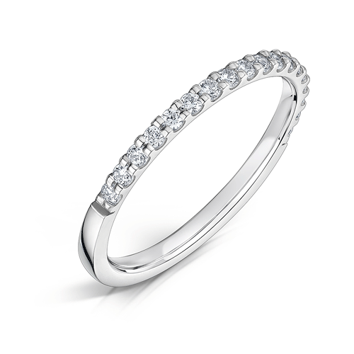 1.5mm wide platinum ring with round diamonds set half way around in a claw setting on a white background.